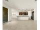 Open concept kitchen with island and stainless steel appliances at 36914 W La Paz St, Maricopa, AZ 85138