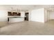 Modern kitchen featuring dark cabinetry, granite countertops, and stainless steel appliances at 36914 W La Paz St, Maricopa, AZ 85138