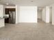 Living room with tile floors, open to kitchen and hallway at 36914 W La Paz St, Maricopa, AZ 85138