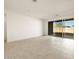 Bright living room with tile floors and sliding glass doors leading to the backyard at 36914 W La Paz St, Maricopa, AZ 85138