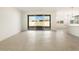 Bright and airy living room with tile floors and sliding glass doors at 36914 W La Paz St, Maricopa, AZ 85138