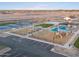 Aerial view of a vibrant playground with play structures and shaded areas at 36914 W La Paz St, Maricopa, AZ 85138