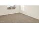 Bright bedroom with carpeted floor and window at 36915 W Prado St, Maricopa, AZ 85138