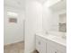 Bathroom boasts tile flooring, a walk-in shower and double sink vanity with white cabinets at 8612 W Warner St, Tolleson, AZ 85353