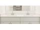 Close up of a bathroom vanity with double sinks and chrome faucets at 8612 W Warner St, Tolleson, AZ 85353