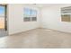 Bedroom with tiled floor, sliding glass door, and windows offering natural light at 8612 W Warner St, Tolleson, AZ 85353