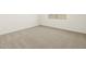 Bedroom featuring neutral carpet, base trim and a window for natural light at 8612 W Warner St, Tolleson, AZ 85353
