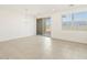 Bright dining area with a sliding glass door, modern chandelier, and large window at 8612 W Warner St, Tolleson, AZ 85353