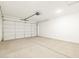 Spacious two-car garage with concrete floor and a large door, providing ample parking and storage space at 8612 W Warner St, Tolleson, AZ 85353