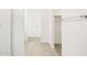 Hallway featuring tile flooring and a walk in closet at 8612 W Warner St, Tolleson, AZ 85353