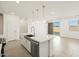 Modern kitchen island with a stainless steel dishwasher, sink, and pendant lighting at 8612 W Warner St, Tolleson, AZ 85353