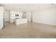 Open-concept living space featuring tile flooring, white kitchen with stainless steel appliances at 8612 W Warner St, Tolleson, AZ 85353