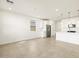 Open concept living area with tile flooring, white cabinets, and kitchen island at 8612 W Warner St, Tolleson, AZ 85353