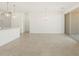 Bright living area featuring tile flooring, white cabinets, and modern lighting at 8612 W Warner St, Tolleson, AZ 85353