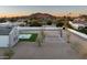 A sprawling backyard with a pool, sports court, manicured turf, and mountain views at 9810 N 57Th St, Paradise Valley, AZ 85253