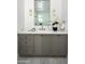 Stylish bathroom with gray vanity, marble countertop, and modern lighting fixtures at 9810 N 57Th St, Paradise Valley, AZ 85253