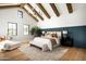 A grand bedroom with vaulted ceilings, exposed wood beams and wainscoting detail at 9810 N 57Th St, Paradise Valley, AZ 85253