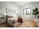This bedroom features a cozy platform bed, sleek black-framed windows, and modern decor at 9810 N 57Th St, Paradise Valley, AZ 85253