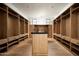 A luxurious walk-in closet with custom wood shelving, drawers and an island at 9810 N 57Th St, Paradise Valley, AZ 85253