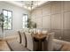 Bright dining room featuring a modern chandelier, neutral colors, and wood floors at 9810 N 57Th St, Paradise Valley, AZ 85253