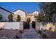 Exterior dusk shot of a well landscaped single Gathering home with stone and stucco accents at 9810 N 57Th St, Paradise Valley, AZ 85253