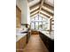 Spacious kitchen with a vaulted ceiling, marble countertops, stainless steel appliances, and a large central island at 9810 N 57Th St, Paradise Valley, AZ 85253