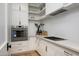 Modern kitchen with white cabinets, stainless steel appliances, quartz countertops, and minimalist design elements at 9810 N 57Th St, Paradise Valley, AZ 85253