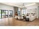 Open concept living room with stone fireplace, neutral palette, and access to pool at 9810 N 57Th St, Paradise Valley, AZ 85253