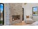 Living room featuring a stunning stone fireplace and comfortable seating at 9810 N 57Th St, Paradise Valley, AZ 85253