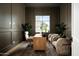 Sophisticated home office with custom millwork, hardwood floors, and ample natural light from a large window at 9810 N 57Th St, Paradise Valley, AZ 85253