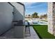 Well-equipped outdoor kitchen and bar area overlooking the pool and landscaped yard at 9810 N 57Th St, Paradise Valley, AZ 85253