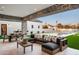 A spacious outdoor patio with comfortable lounge seating, a dining area, and a view of the pool at 9810 N 57Th St, Paradise Valley, AZ 85253