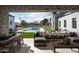 Relaxing outdoor patio with a dining table, a large sofa, and a view of the pool at 9810 N 57Th St, Paradise Valley, AZ 85253