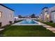 An elevated rear view of a backyard pool and spa with artificial lawn at 9810 N 57Th St, Paradise Valley, AZ 85253
