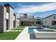 A luxurious pool and spa, complimented by a stone home exterior and lush backyard at 9810 N 57Th St, Paradise Valley, AZ 85253
