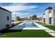 Luxurious pool surrounded by green turf and modern architectural features at 9810 N 57Th St, Paradise Valley, AZ 85253