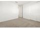 Carpeted bedroom with a double door closet and bright white paint at 20293 N 225Th Dr, Surprise, AZ 85387