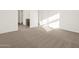 Bedroom featuring neutral carpet and two entry doorways bathed in natural light at 20293 N 225Th Dr, Surprise, AZ 85387