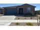 Charming single-story home with a two car garage, desert landscaping, and inviting curb appeal at 20293 N 225Th Dr, Surprise, AZ 85387