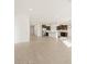 Spacious living area with tile floors, seamlessly connected to a modern kitchen featuring dark wood cabinets at 20293 N 225Th Dr, Surprise, AZ 85387
