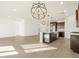 Open-concept living space with kitchen island, pendant lights, and tile flooring at 20293 N 225Th Dr, Surprise, AZ 85387