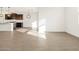 Open concept living space with tile floors, white walls, and modern lighting fixtures at 20293 N 225Th Dr, Surprise, AZ 85387