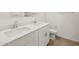 Bright bathroom with double sinks, quartz countertops, and modern fixtures at 20357 N 225Th Dr, Surprise, AZ 85387