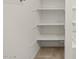 Bright walk-in bathroom closet with multiple shelves at 20357 N 225Th Dr, Surprise, AZ 85387
