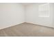 Bright bedroom featuring neutral carpet and a sunny window at 20357 N 225Th Dr, Surprise, AZ 85387