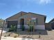 Single-story home with a mix of modern style and desert landscaping on a sunny day at 20357 N 225Th Dr, Surprise, AZ 85387