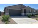 Beautiful one-story home with desert landscaping and a two-car garage at 20357 N 225Th Dr, Surprise, AZ 85387