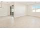 Bright dining room features tile flooring and sliding glass door access to backyard at 22526 W Tonopah Dr, Surprise, AZ 85387