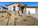 Single story house with a two-car garage, light colored exterior, and small front yard at 22526 W Tonopah Dr, Surprise, AZ 85387