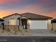 Single story house with a two-car garage and desert landscaping at 22526 W Tonopah Dr, Surprise, AZ 85387